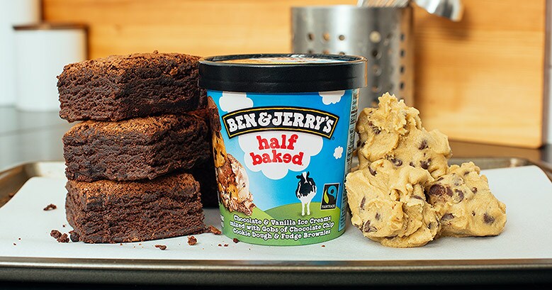 Pint of Half Baked between a pile of brownies and a pile of cookie dough 