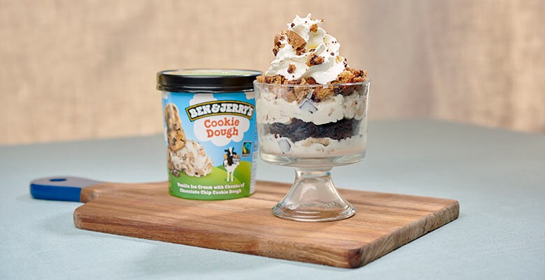 Pint of Cookie Dough Ice Cream next to ice cream trifle on cutting board