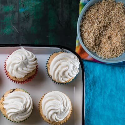 Frosted cupcakes with coconut in a bowl