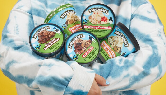 Persons arms filled with pints of Ben & Jerry's Ice Cream