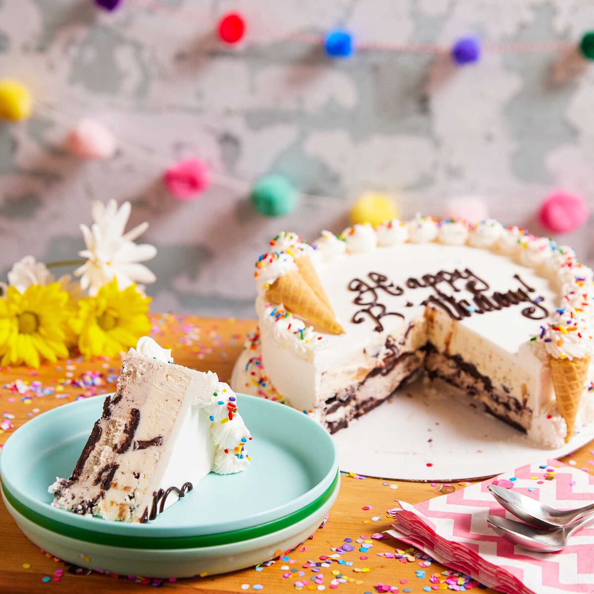 Happy Birthday ice cream cake with a piece on a plate