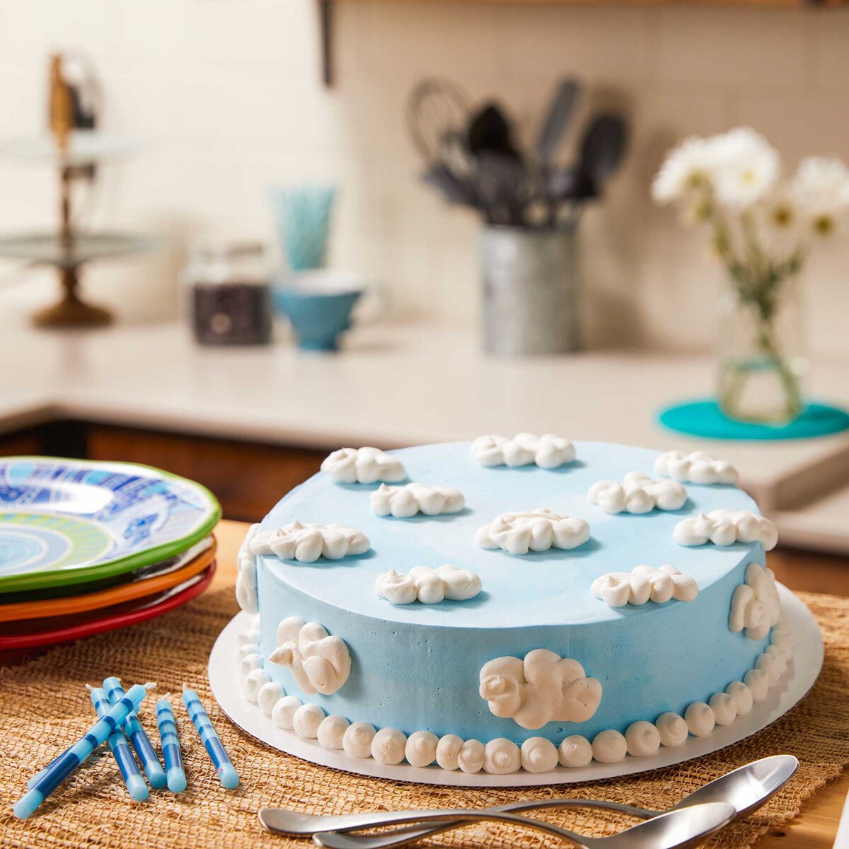 Ice cream cake on a table in front of a kitchen