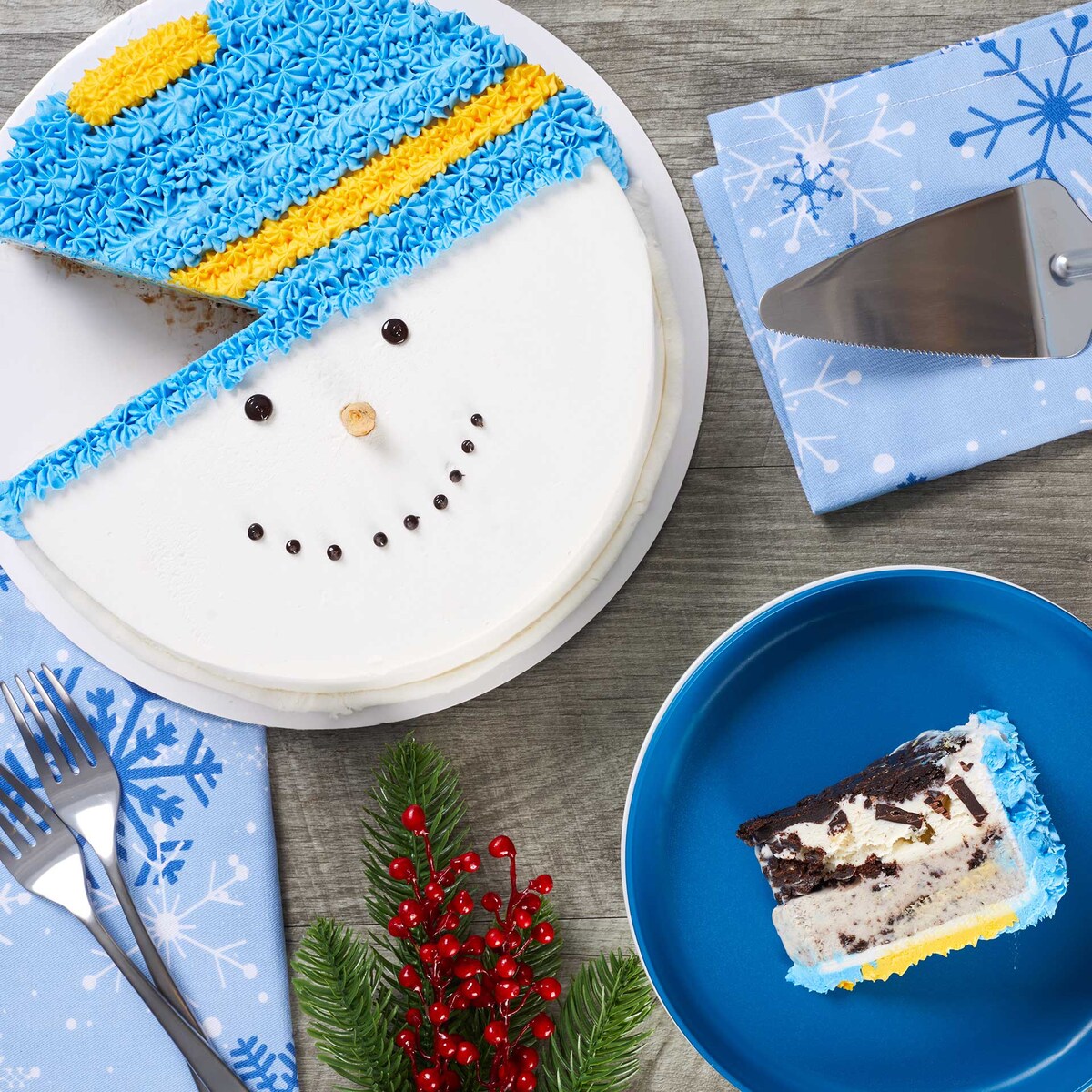 Snowman ice cream cake with a slice removed